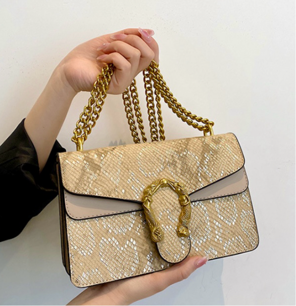 Golden sling bag with designer buckle.