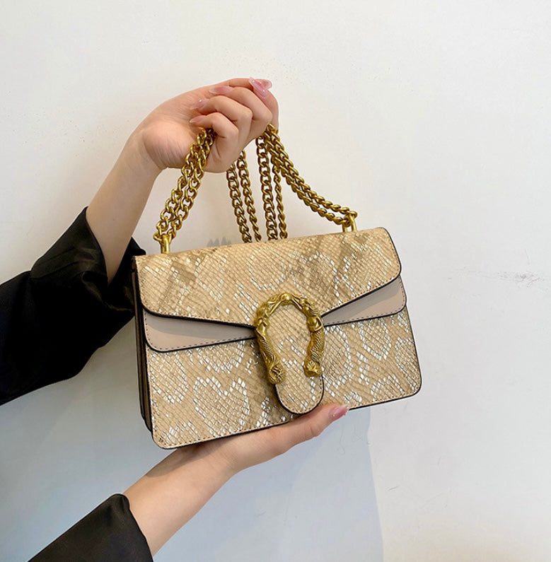 Golden sling bag with designer buckle.