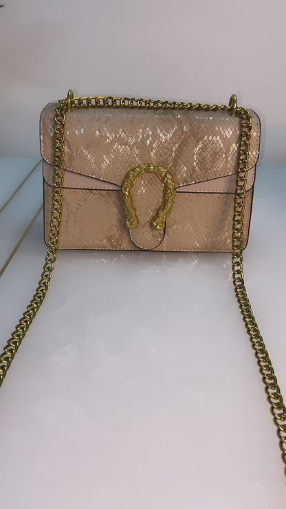 Golden sling bag with designer buckle.